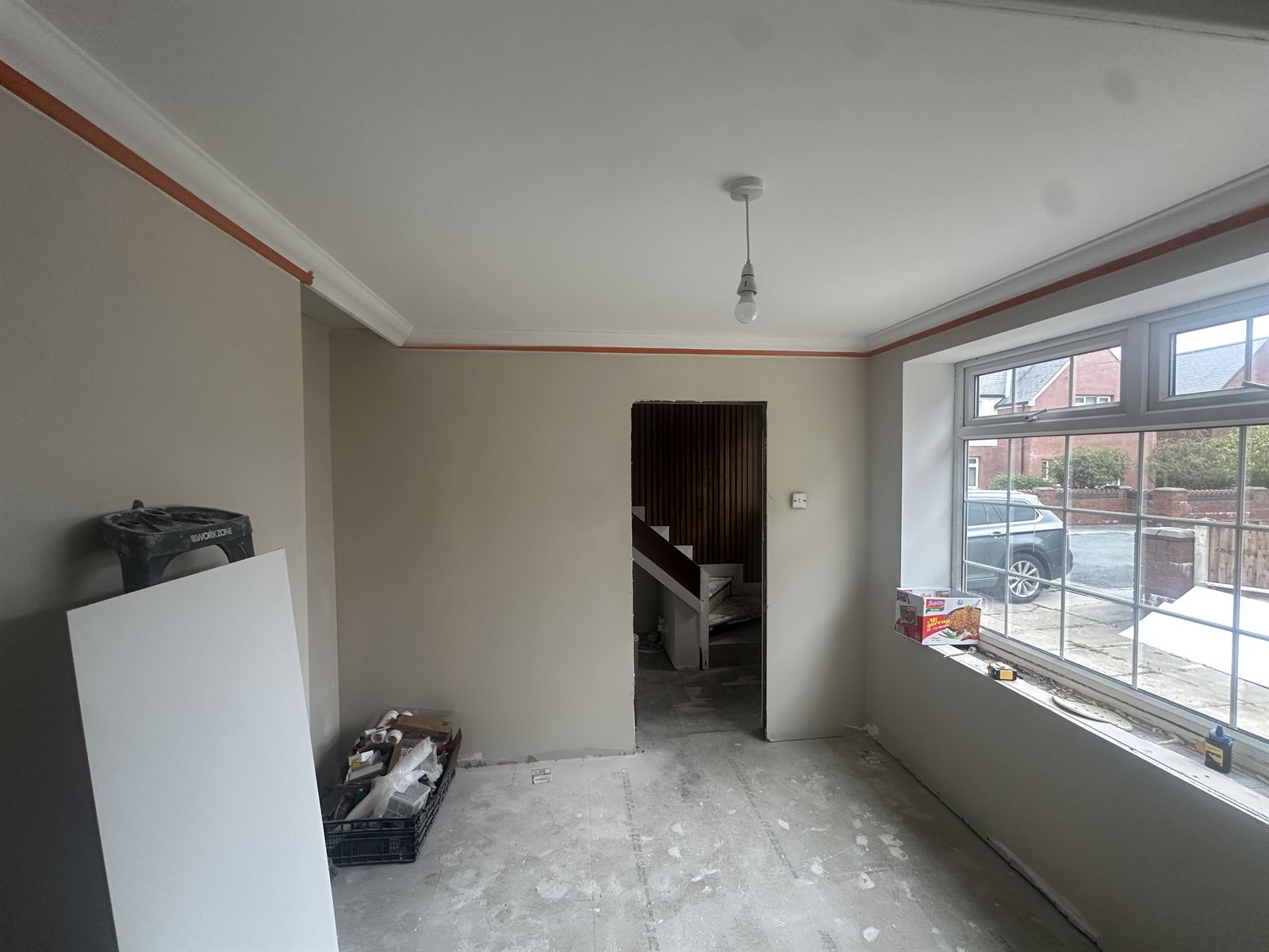 Freshly plastered and decorated living room with large bay window