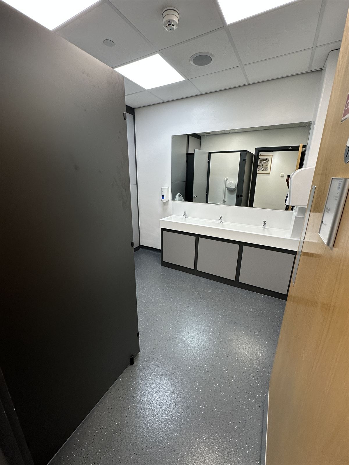 Washroom vanity area with mirror cabinet and panelled walls